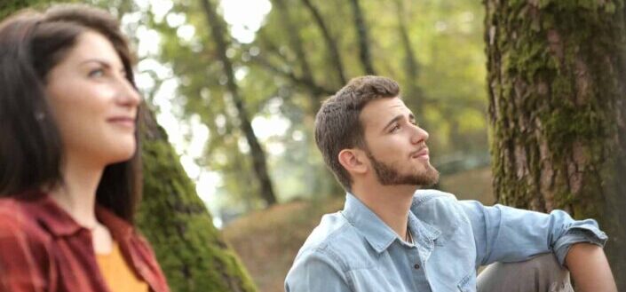 Man and Woman Thoughtfully Looking Away