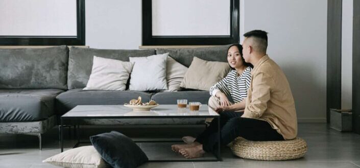 Couple sitting in clean living room