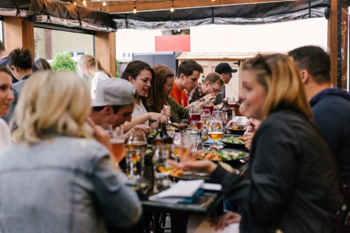 People Eating a Meal Around a Table