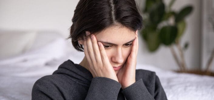 Worried woman touching her face