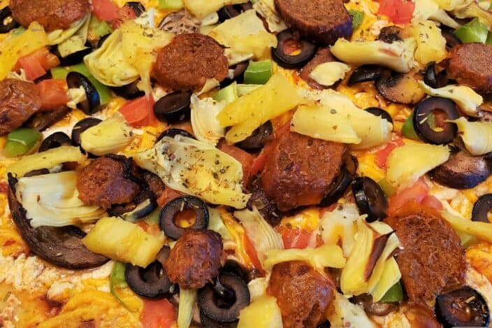 a large pizza with pineapple on top