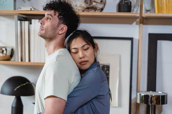 A Woman Hugging Her Partner from Behind - Playing Hard To Get 