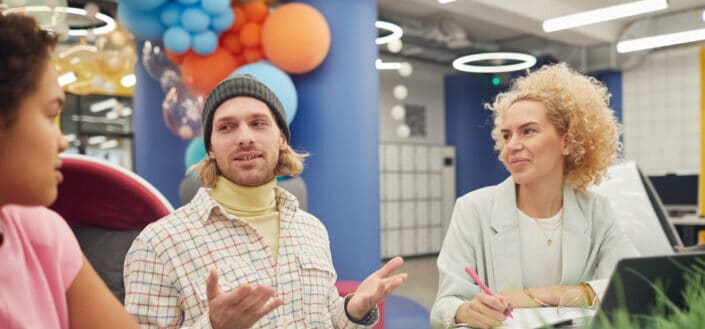 Three people discussing at work