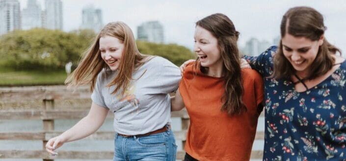 three women walking on docks