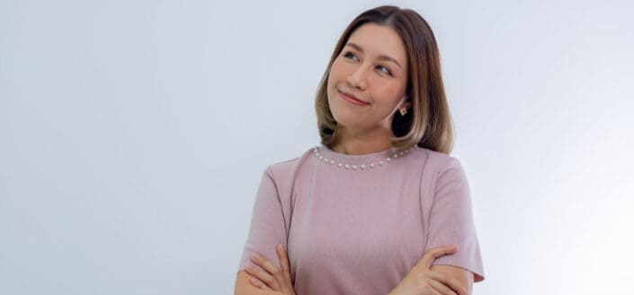 Woman in pink blouse wondering