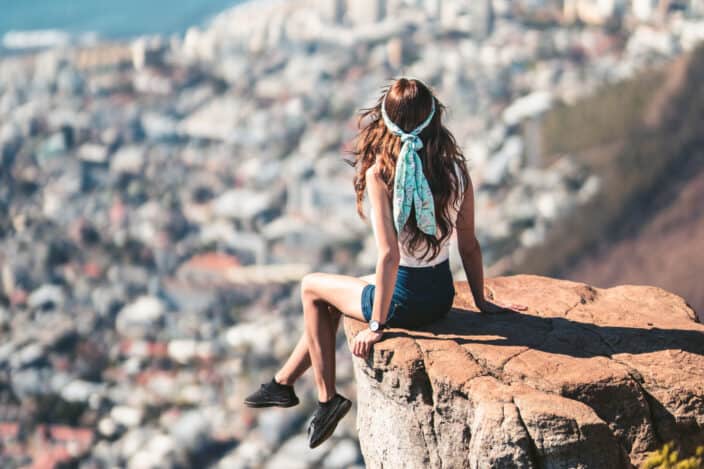 Woman sitting on the edge of a cliff