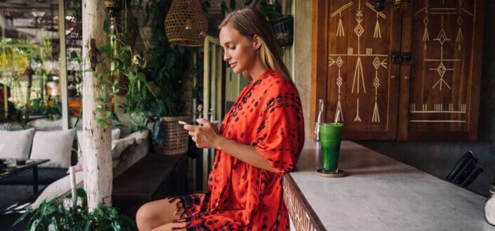 Woman sitting beside a bar counter
