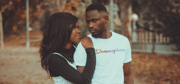 Woman standing behind a man