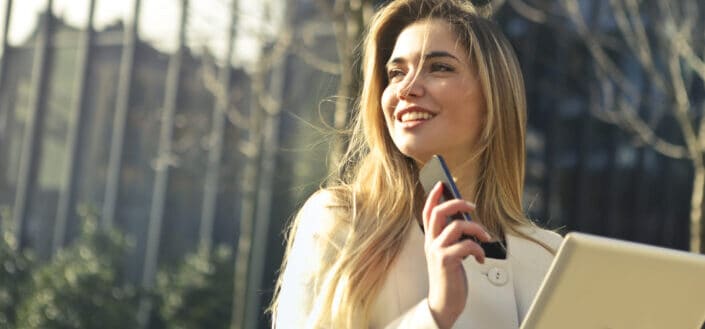 Woman holding smartphone and tablet