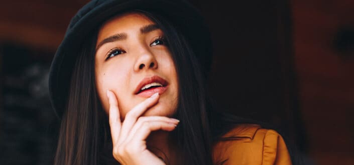 Woman with hand around chin