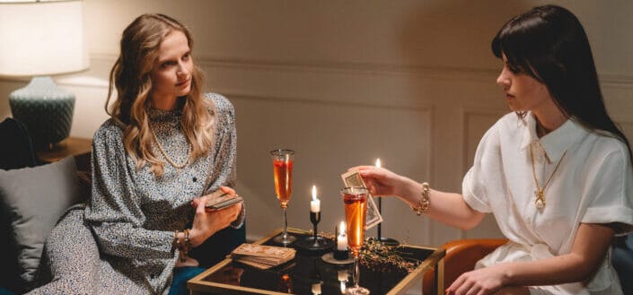 Two ladies looking at tarot card reading