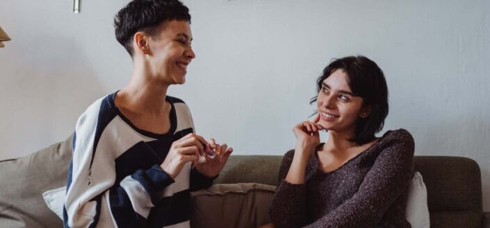 Women Sitting on a Couch Talking