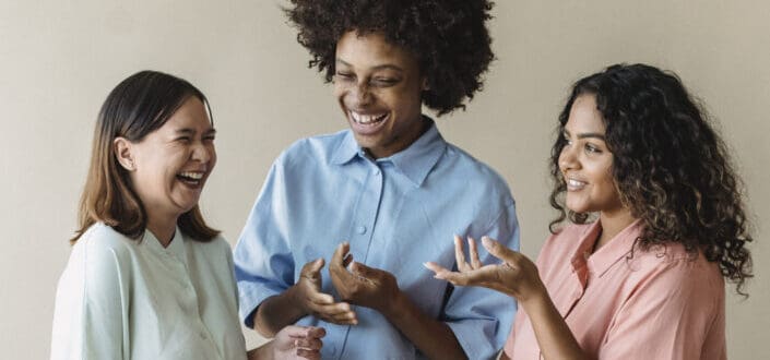 three work colleagues discussing something funny