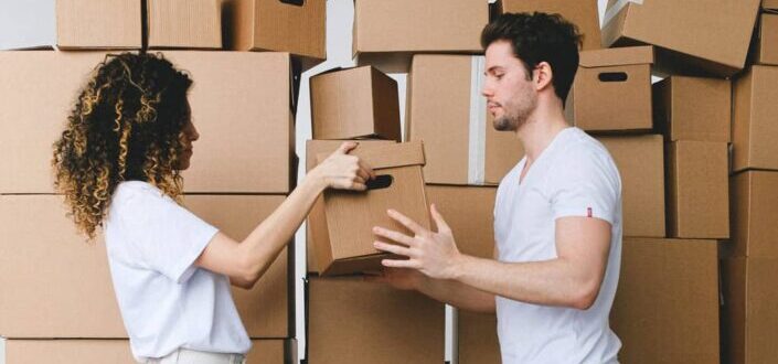 Couple Carrying Moving Boxes