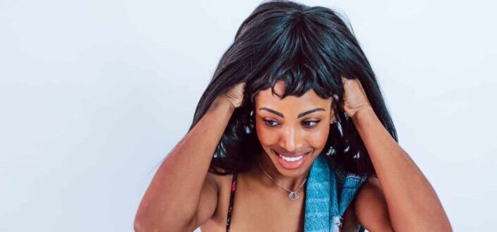 Woman Putting on a Wig