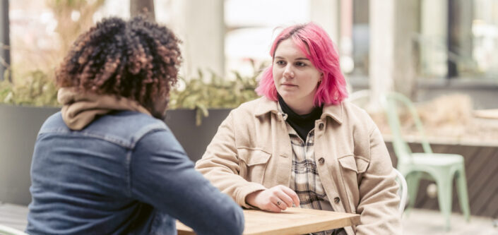 Friends Sitting at a Cafe Table