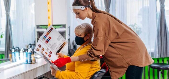 Female Hairdresser Working With Client