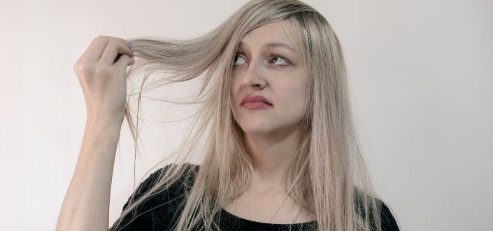 Woman in Black Shirt Holding Her Hair