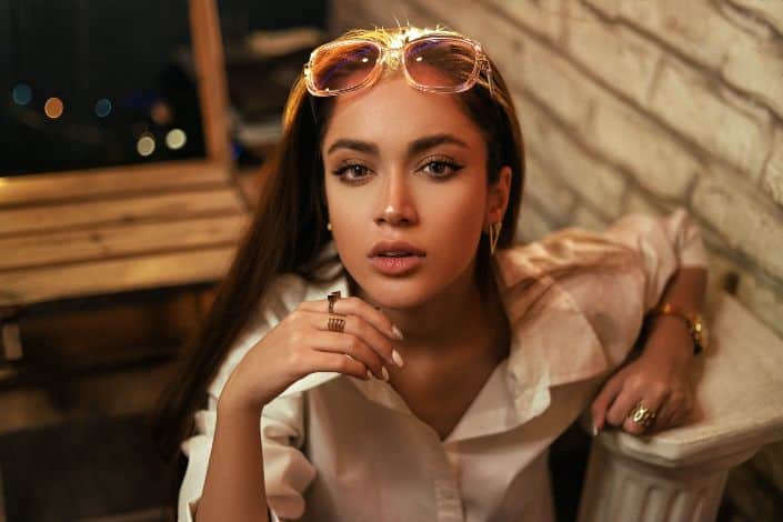 Woman in a White Shirt and Sunglasses