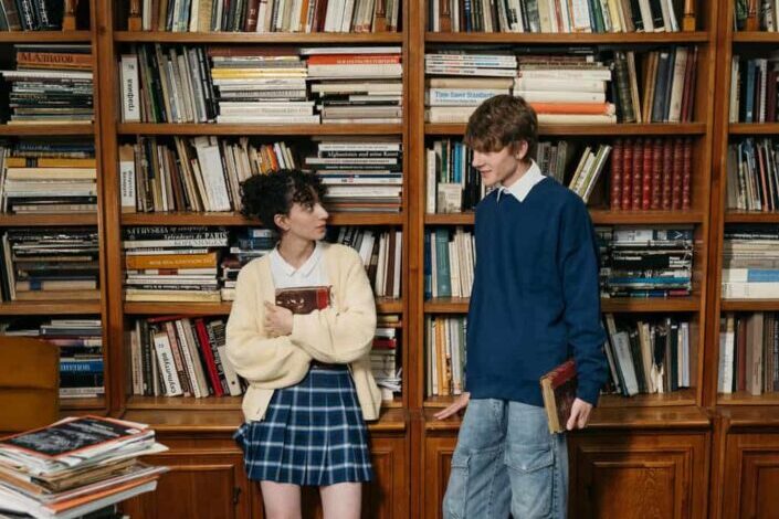 Man and Woman Looking at Each Other in the Library