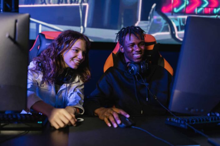 Man and woman smiling while playing videogame