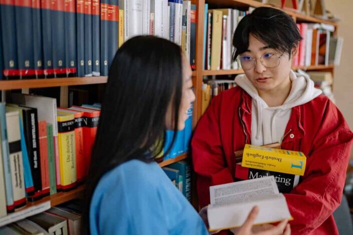 Man and woman talking inside the library