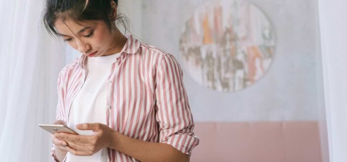 Woman Browsing Through Her Phone