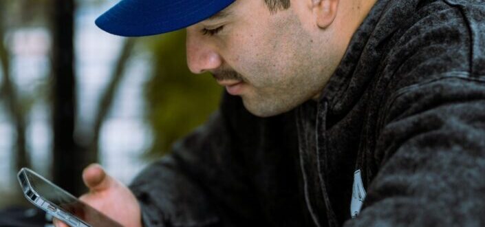 Man Checking His Phone Outdoors