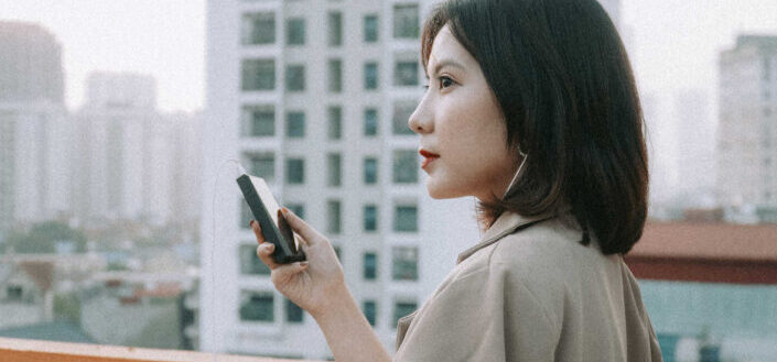 Woman in Beige Blazer Listening to Music