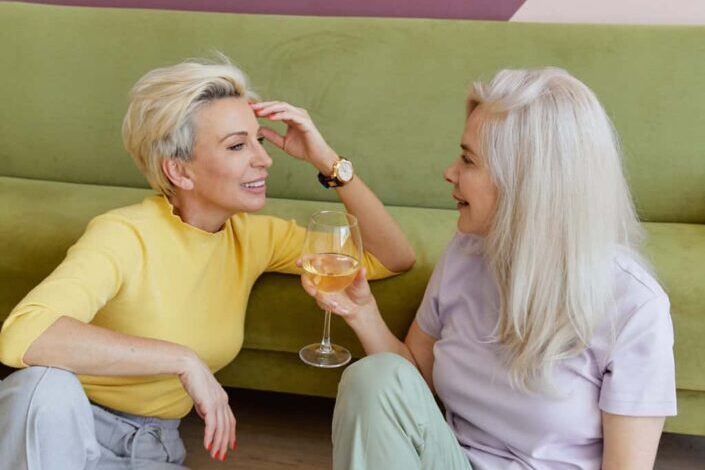 Older Women Sitting on the Floor While Having Conversation