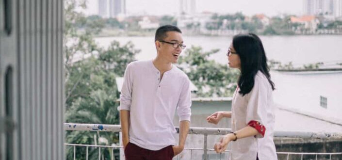Man and Woman Standing By Balcony