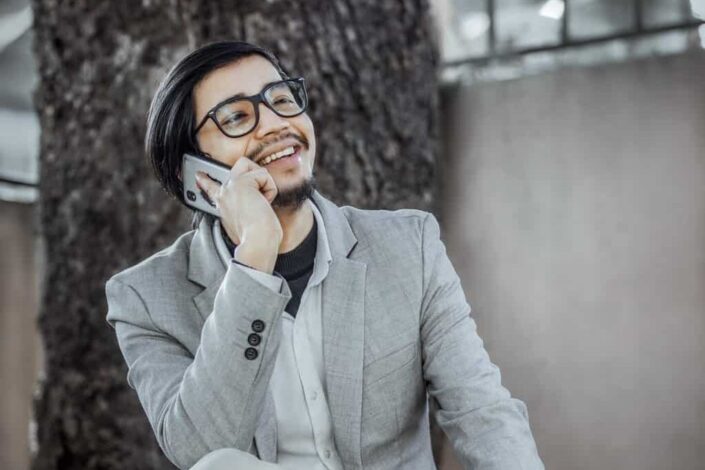 Man Wearing Suit Jacket Talking on the Phone