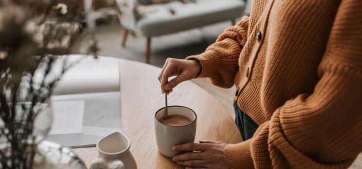 A Person Mixing Hot Chocolate in Mug