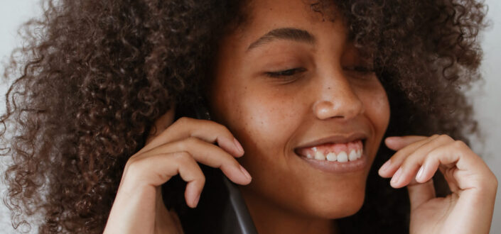 Woman Wearing a Brown Sweater on a Phone Call