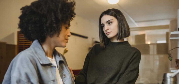 Caring woman supporting suffering girlfriend