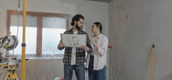 Couple Holding a House Blueprint