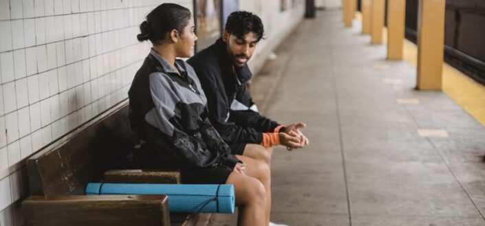 Couple Sitting on Bench in Metro Station