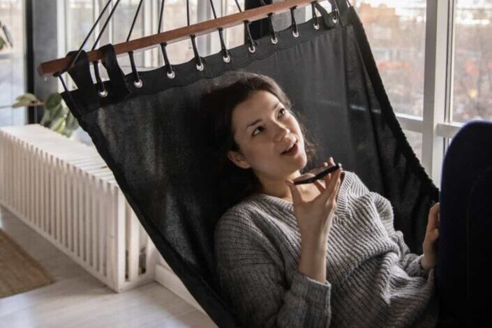 Woman Talking on Smartphone While Lying in Hammock