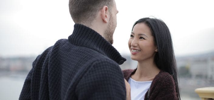 Happy Couple Standing on the Bridge