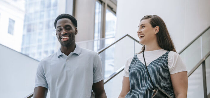 Happy man and woman going downstairs