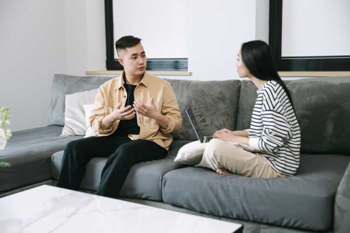 Man and Woman Having a Conversation on the Couch