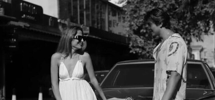 Man Standing Near a Woman Near Car