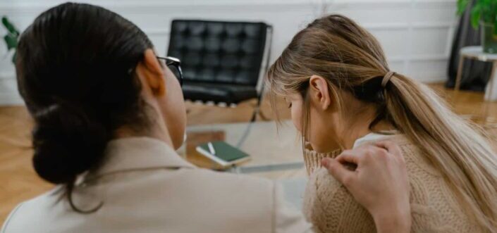 Person comforting the sad woman