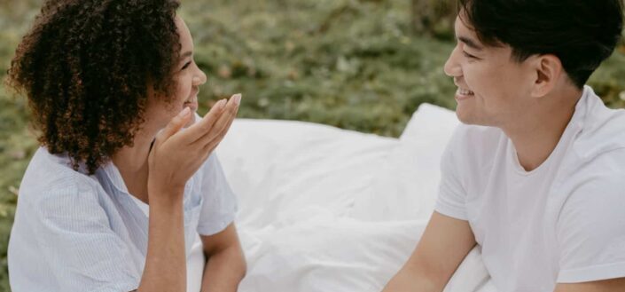 Romantic Couple Talking on the Bed Outdoors