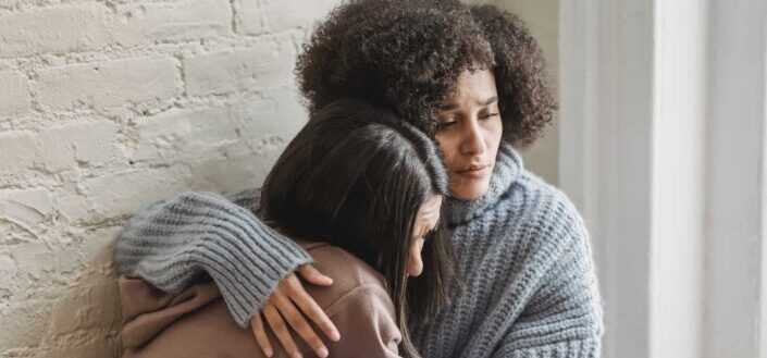 women hugging each other