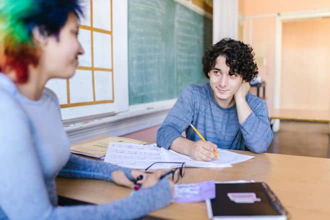 Student Looking Shyly at His Classmate - Signs a Shy Guy Likes You