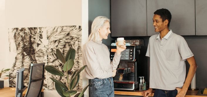 Workers Having Fun Conversation in Office Pantry