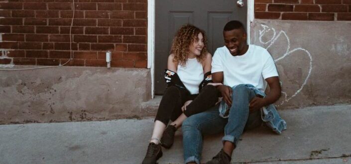 Laughing Man and Woman Sitting Outside Door