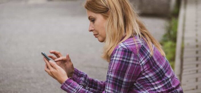 woman sitting and texting