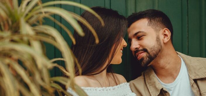 Couple Smiling at Each Other About to Kiss
